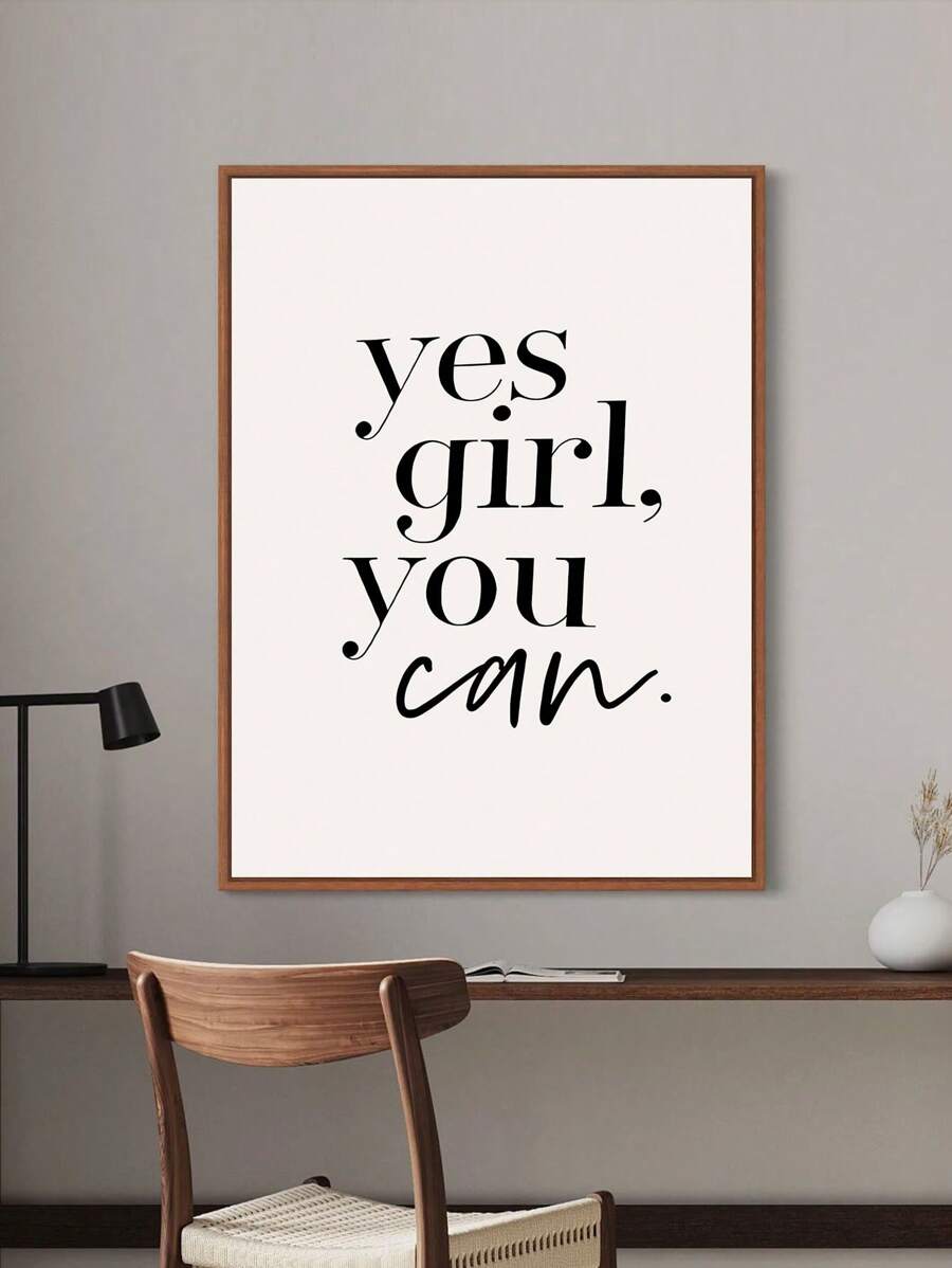 Wood framed Yes Girl You Can wall art above a minimalist study desk