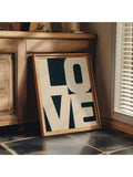 Cream and navy LOVE poster beside warm wood cabinetry