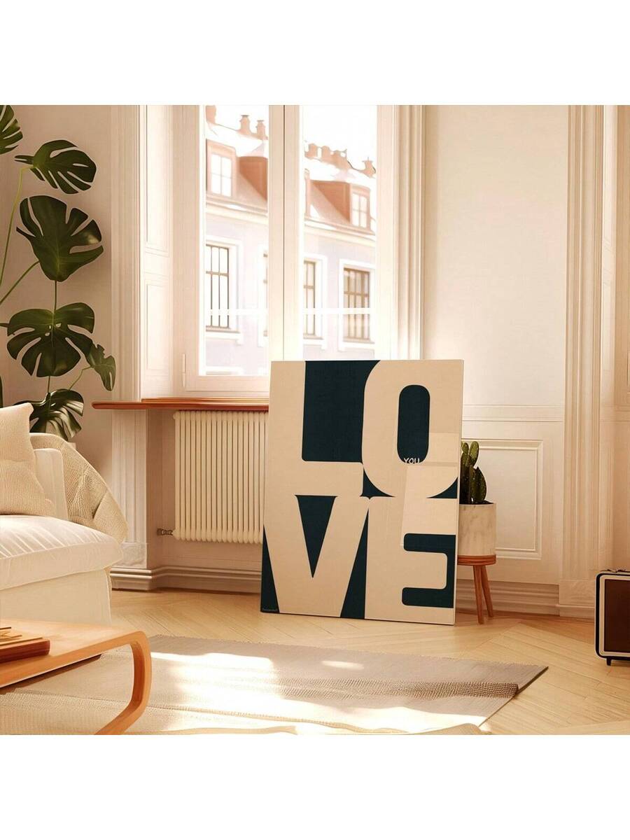 Unframed geometric LOVE canvas in a bright living room