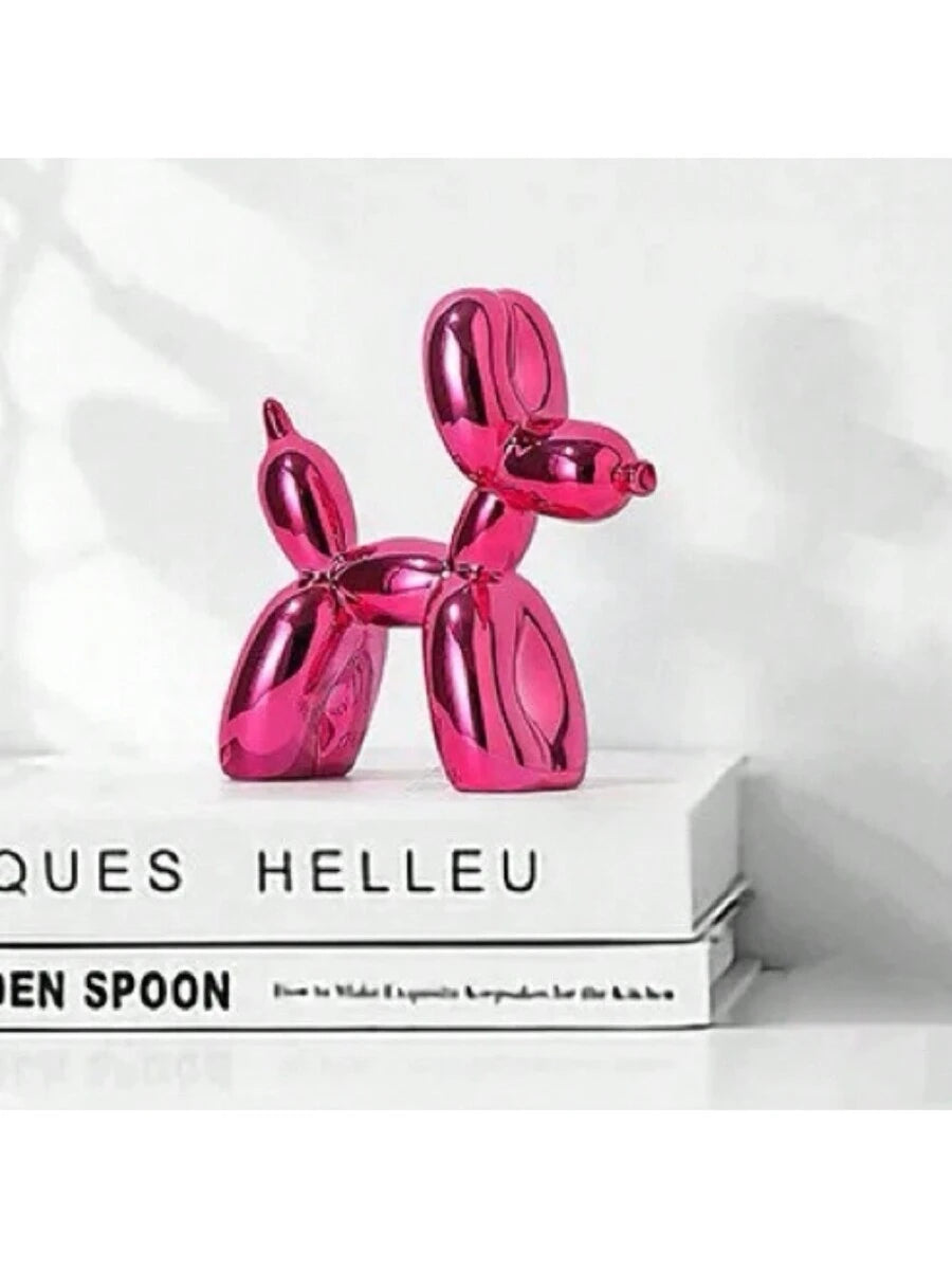 Pink balloon dog sculpture with glossy electroplated finish