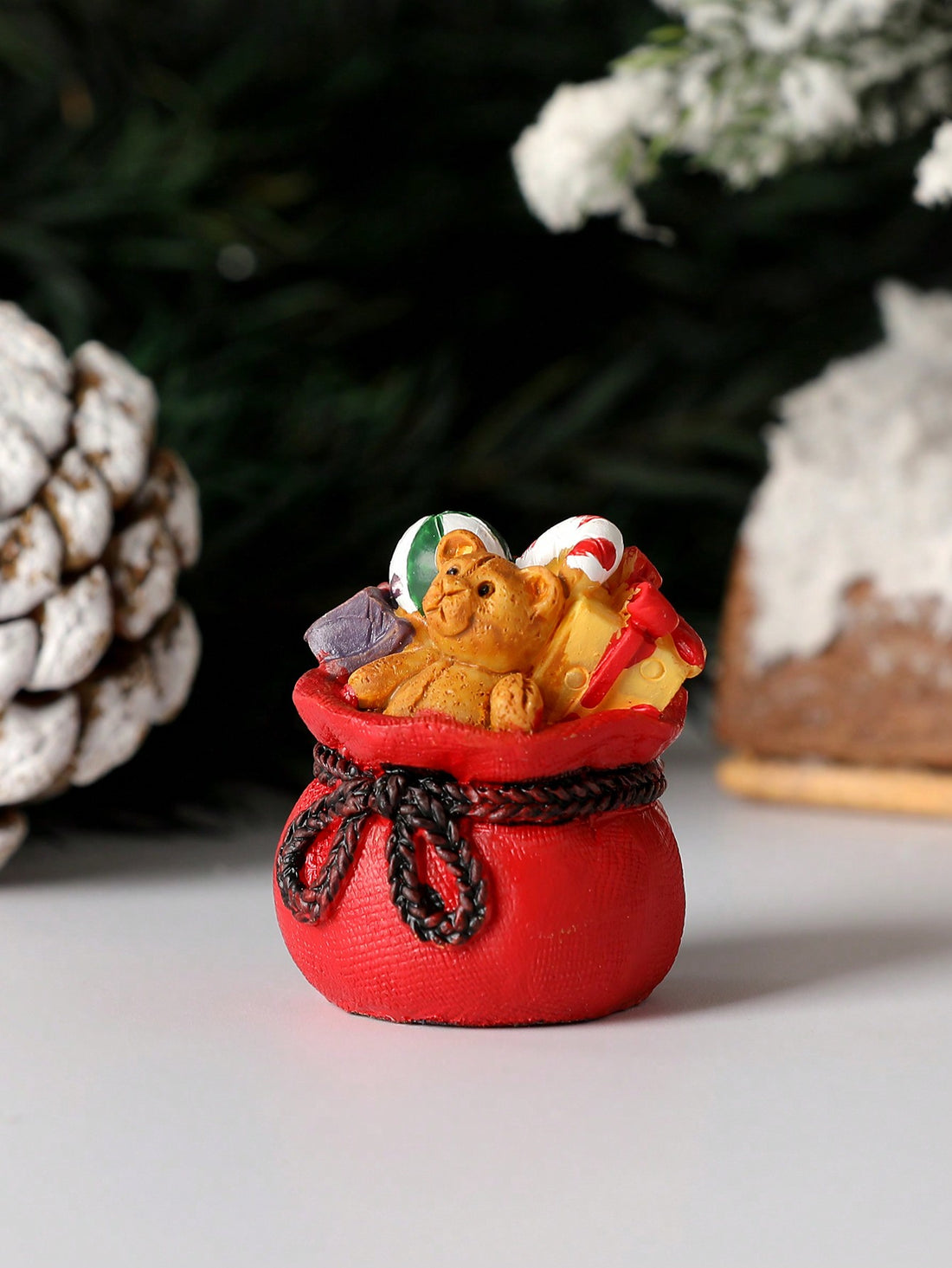 This delightful snowman figurine brings timeless holiday charm to any space. Crafted with meticulous attention to detail, it features a cheerful snowman paired with a coordinating gift bag, making it an ideal accent for seasonal displays. Perfect for tabletops, shelves, or miniature landscape arrangements, this festive ornament captures the warmth and nostalgia of winter celebrations. Its compact size and versatile design complement both traditional and contemporary décor styles, while the included gift bag