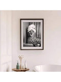 Dark framed matted cheetah towel turban print above a bathroom table