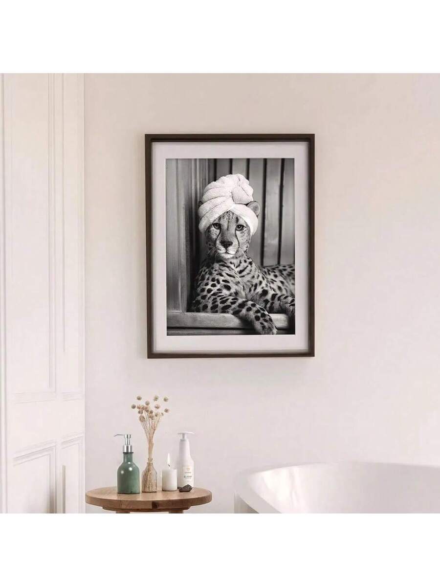 Dark framed matted cheetah towel turban print above a bathroom table