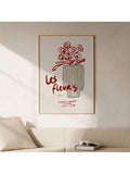 Les fleurs flower and vase print mounted above a cream sofa with books