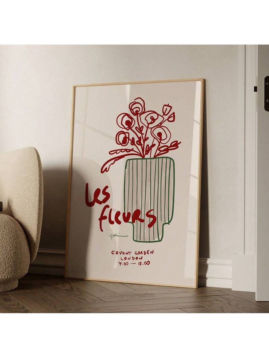 Light wood framed botanical vase artwork displayed in a living room corner