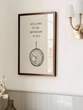 Bathroom disco canvas print beside a brass wall light