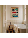 Multicolor lyric canvas hanging above a bathtub in a bright bathroom