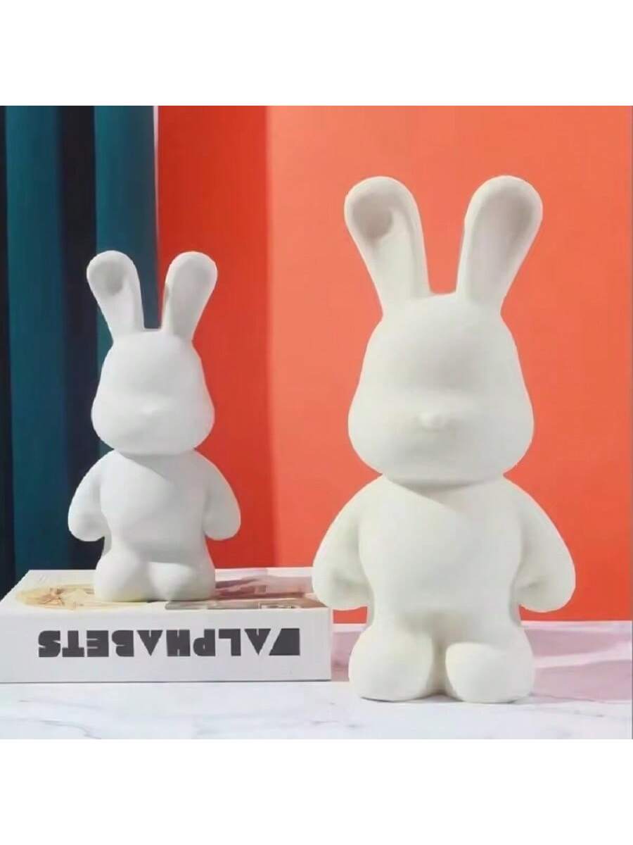 This DIY Fluidal Graffiti Rabbit Piggy Bank combines creativity and functionality, making it the perfect addition to any home decor. With a white base and fluidal graffiti design, this rabbit figurine adds a touch of uniqueness to your space. Use it as a piggy bank to save money or as a decorative piece.
