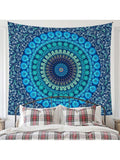 Navy blue and teal mandala tapestry hanging behind bed
