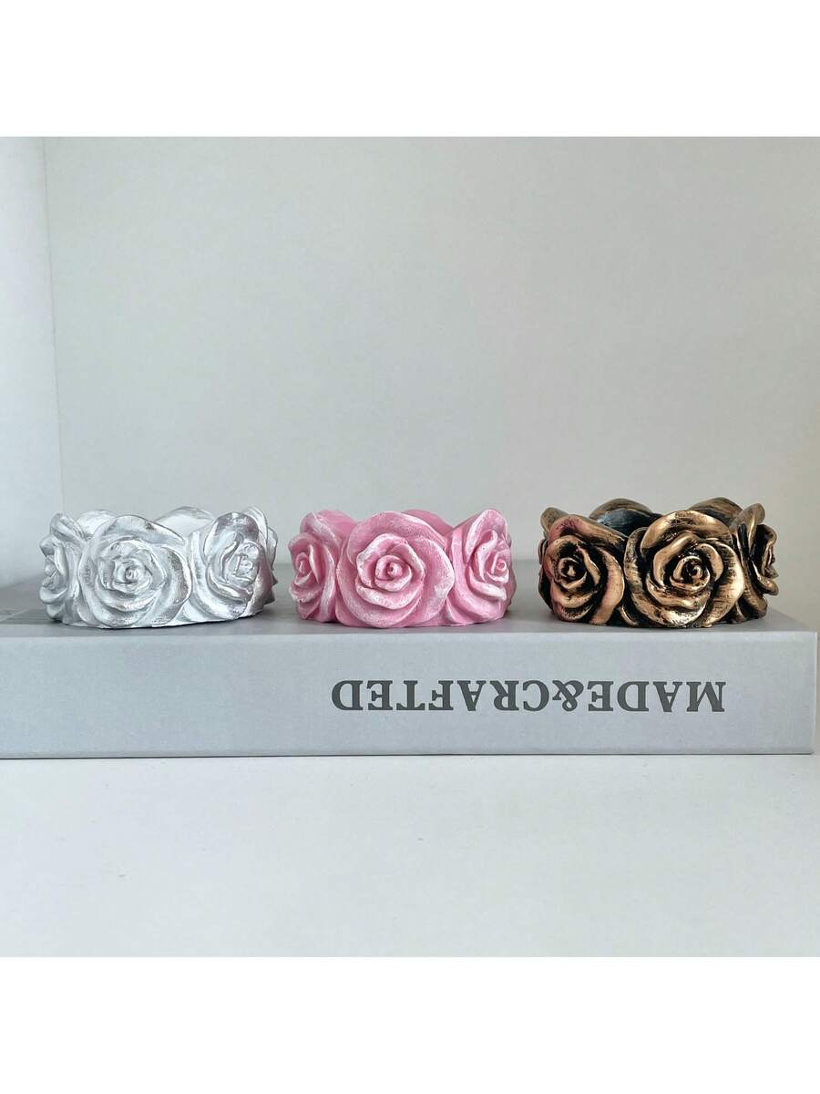 Rose candle holder with lit tealight and sculpted petals
