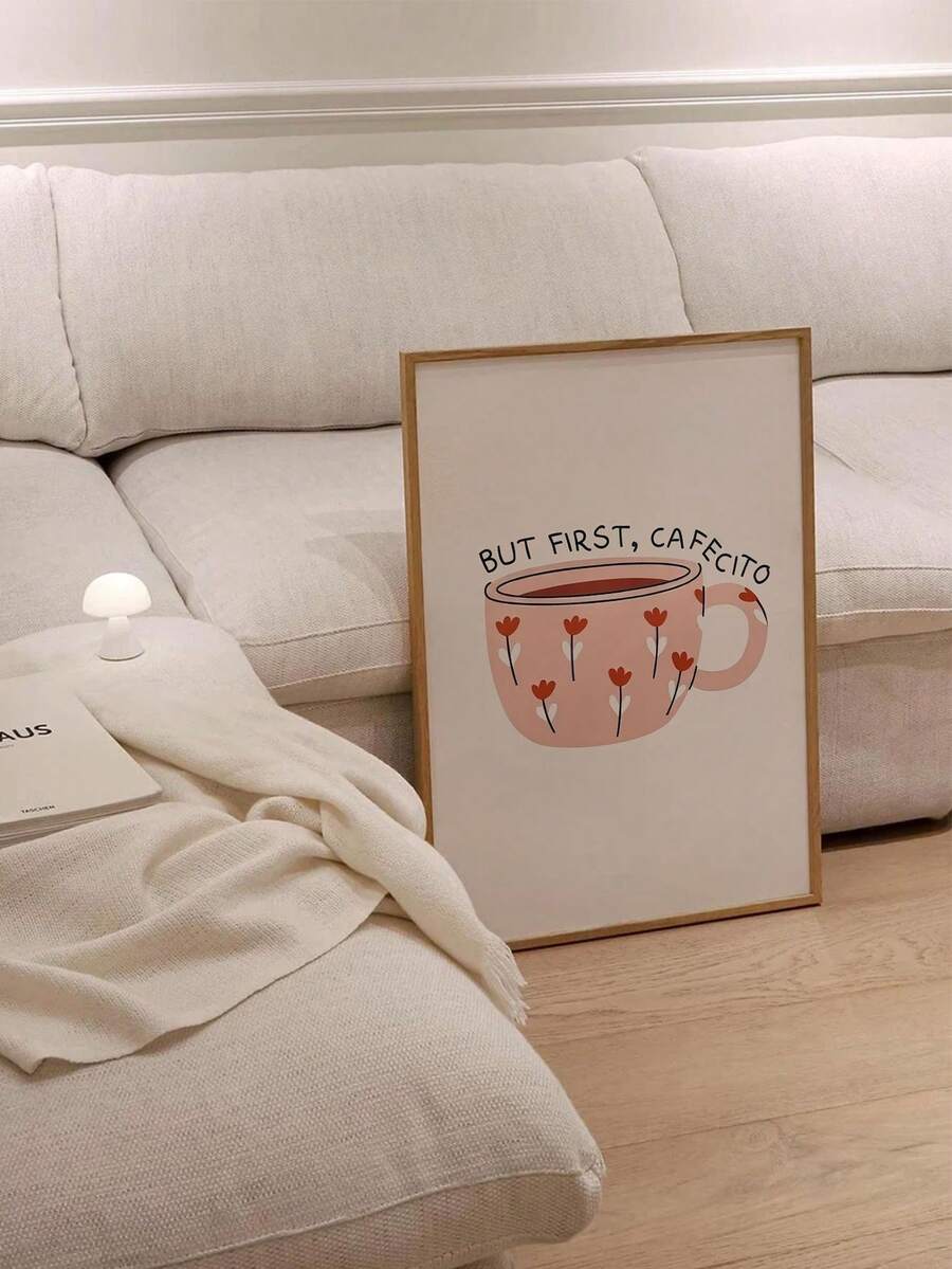 But first cafecito coffee cup wall art displayed beside a sofa