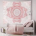 Blush pink floral mandala tapestry used as bedroom wall decor above white bed