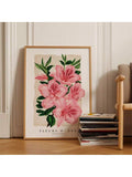 Pink azalea botanical artwork displayed on a wood floor beside stacked books and a chair