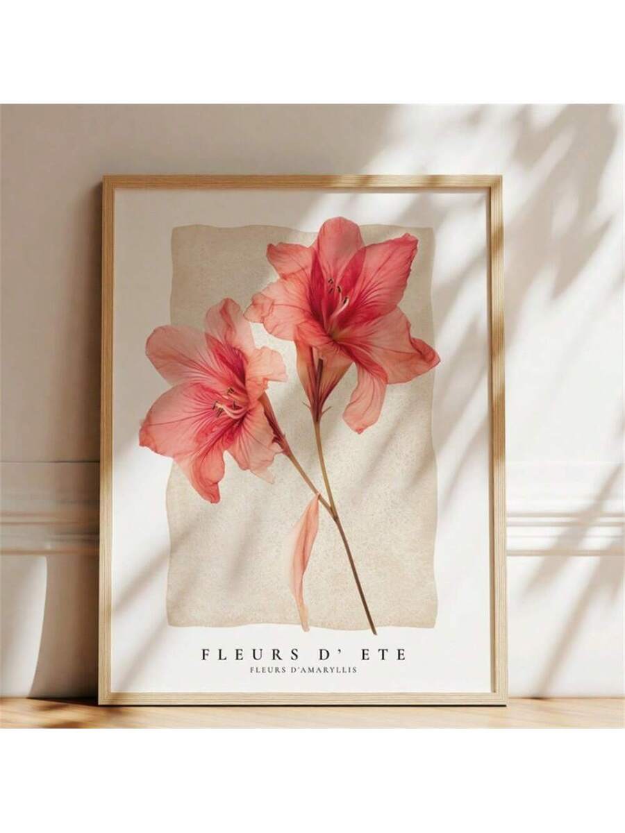 Framed coral amaryllis botanical artwork illuminated by sunlight against a neutral wall