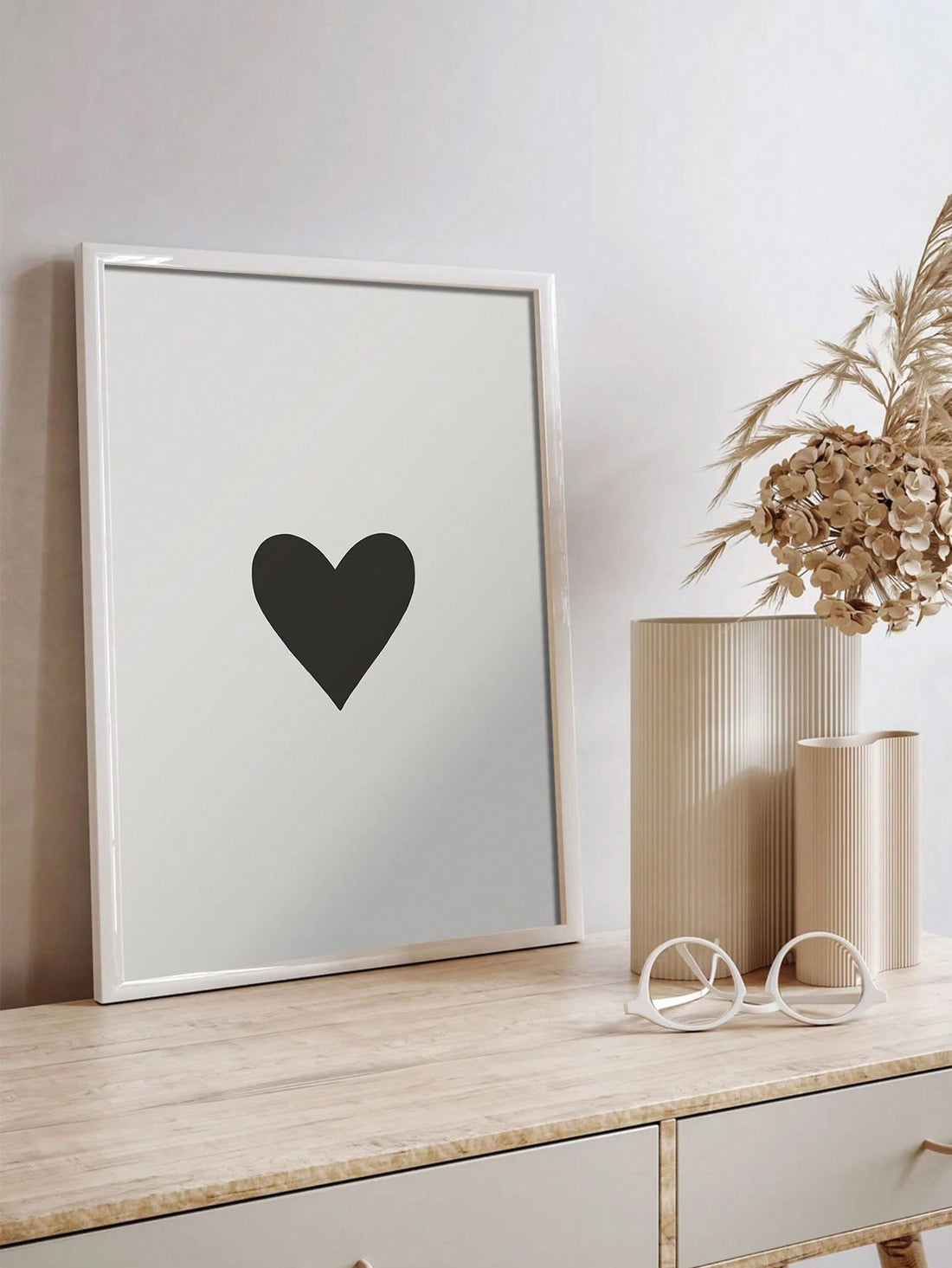 This minimalist heart-shaped canvas art combines striking black and white tones to enhance any modern interior. Its clean lines and simple design create a sophisticated focal point, perfect for adding subtle elegance to living spaces, bedrooms, or offices. Crafted for durability and visual impact, this piece complements contemporary décor with timeless style.