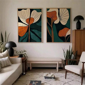 Green and burnt orange botanical wall art set above neutral sofa