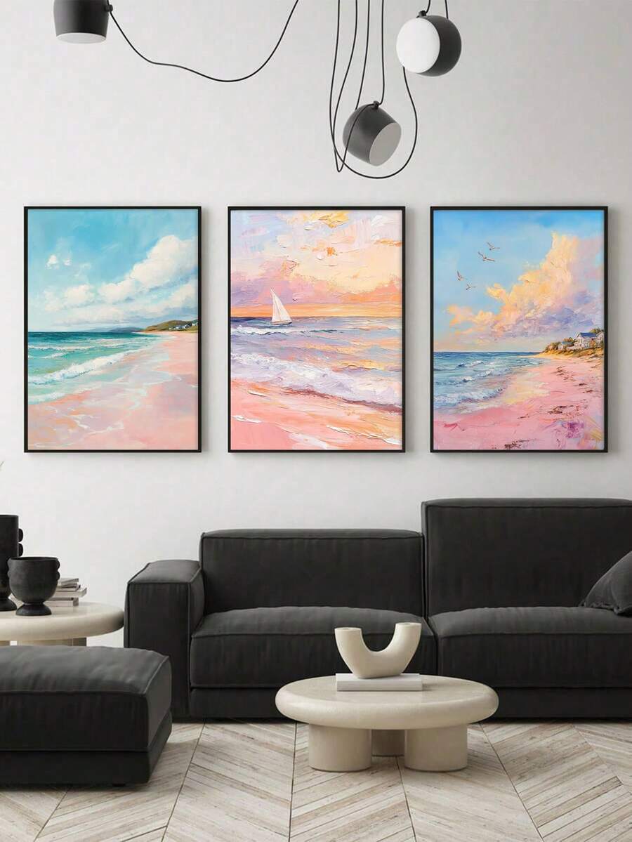 Three framed coastal seascape prints above black sofa in modern living room with hanging lights