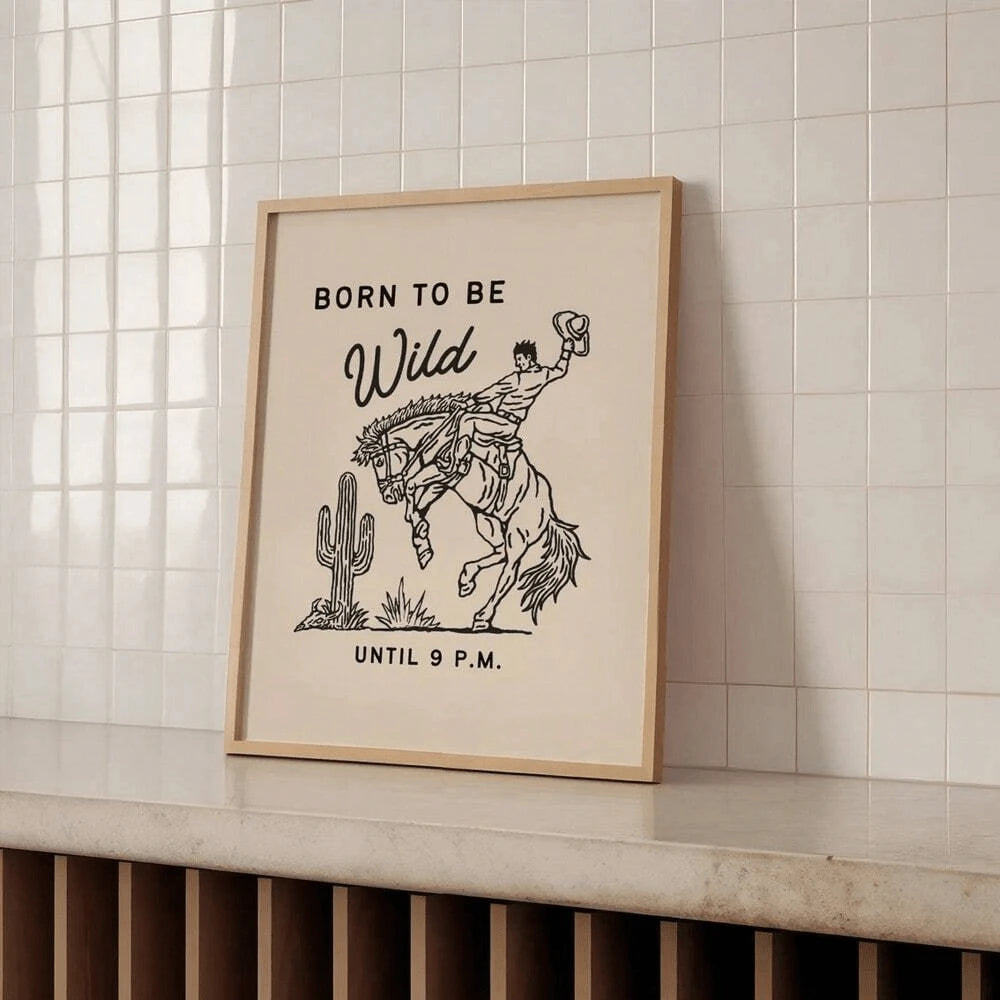 Born To Be Wild rodeo horse print in a natural wood frame in a tiled room