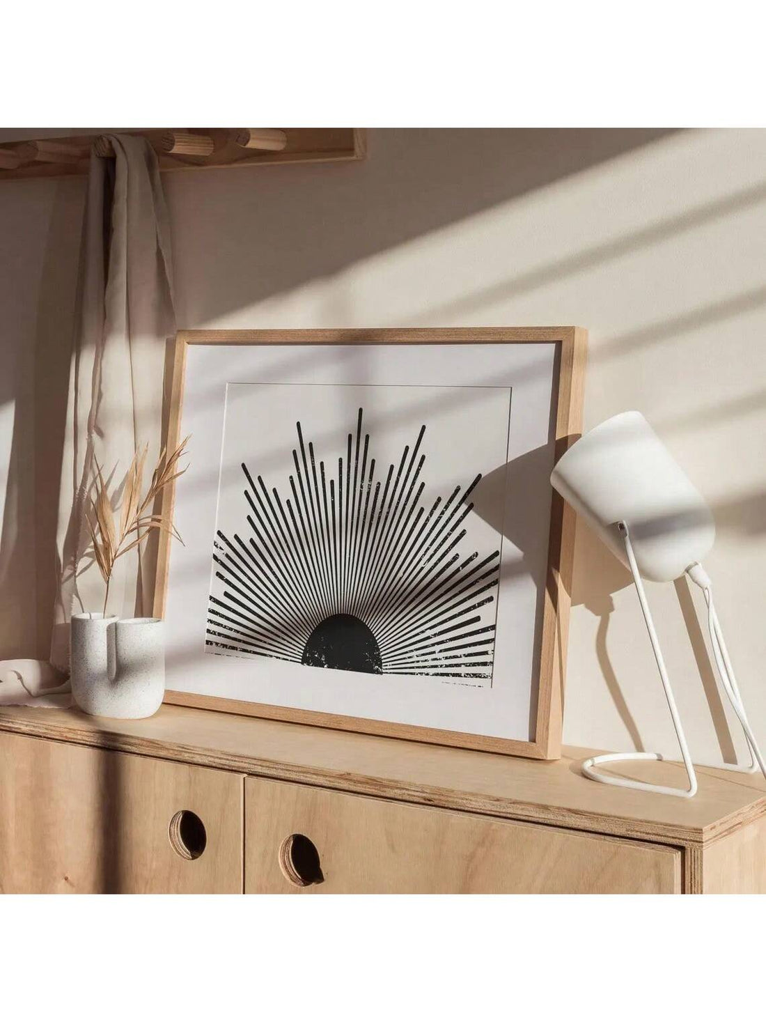 Transform your space with this striking Black and White Sunburst Wall Art. The unframed design showcases clean lines and bold contrast, embodying authentic mid-century modern aesthetics. This versatile piece adds sophisticated geometric interest to living rooms and bedrooms while complementing both minimalist and eclectic décor schemes. The timeless monochromatic palette ensures lasting visual impact in any contemporary interior.