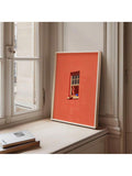 Pink wall art with reader window scene and orange cat on sill