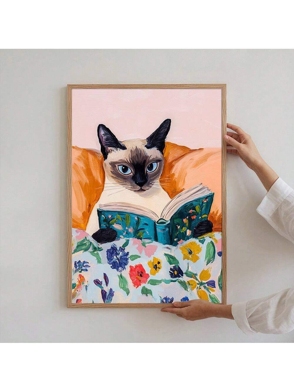 This minimalist art print features a charming cat engrossed in reading, bringing a serene and cozy vibe to any living space. Its simple design complements various decor styles, making it an elegant choice for creating a warm and inviting atmosphere. Perfect for book lovers and cat enthusiasts alike, this unframed poster allows for personalized display options to suit your home’s unique aesthetic.
