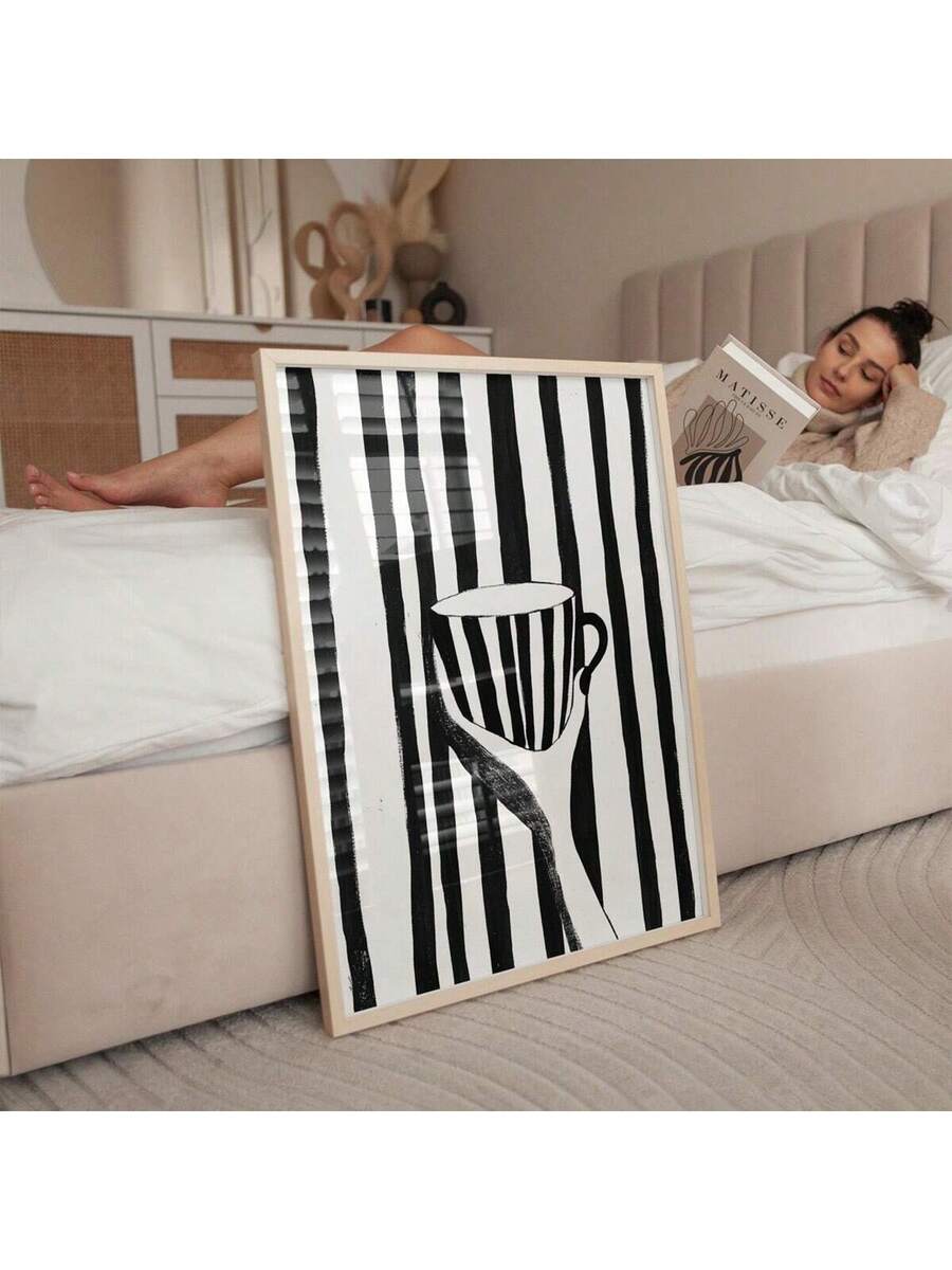 Elevate your kitchen or dining space with this striking minimalist black and white coffee cup wall art print. Featuring clean lines and modern monochrome design, this unframed canvas piece brings contemporary sophistication to any room. The waterproof canvas material ensures durability and longevity, making it perfect for kitchen environments. Its versatile aesthetic complements both modern and transitional interiors, adding visual interest without overwhelming your décor. Display it solo for understated el