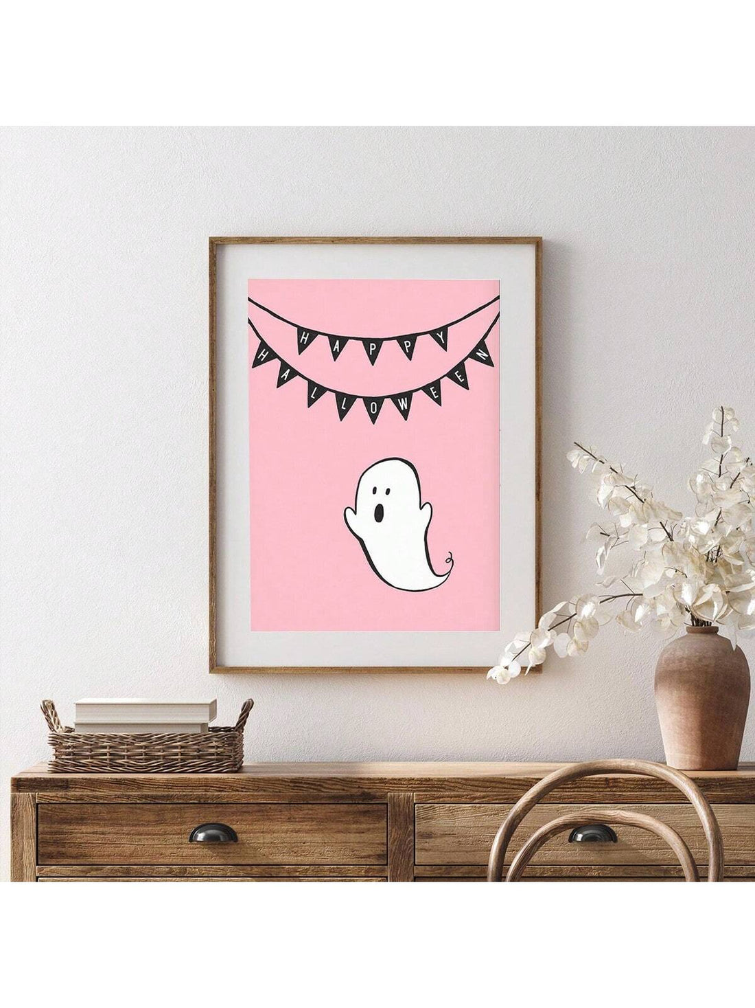Elevate your Halloween decor with this Charming Pink Ghost Wall Art, expertly crafted on a framed canvas. Its unique pink ghost design adds a playful yet spooky touch, perfect for creating a festive atmosphere. Durable and ready to hang, this piece blends seasonal charm with artistic flair, making it an ideal accent for any room seeking a subtle Halloween vibe.