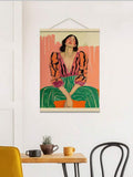 Hanging poster rail woman portrait above small dining table