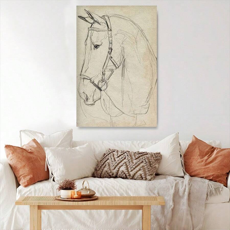 Minimal horse portrait above a sofa with rust pillows and a textured throw