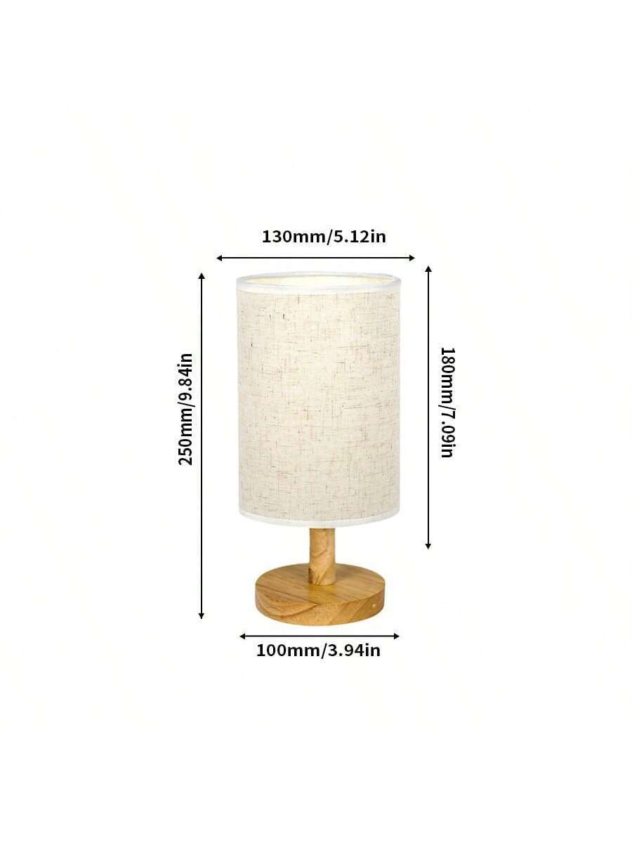 Two small cylindrical fabric desk lamps with wood-look bases glowing warm light