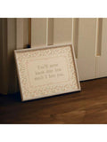 Romantic botanical quote canvas leaning against warm wood paneling