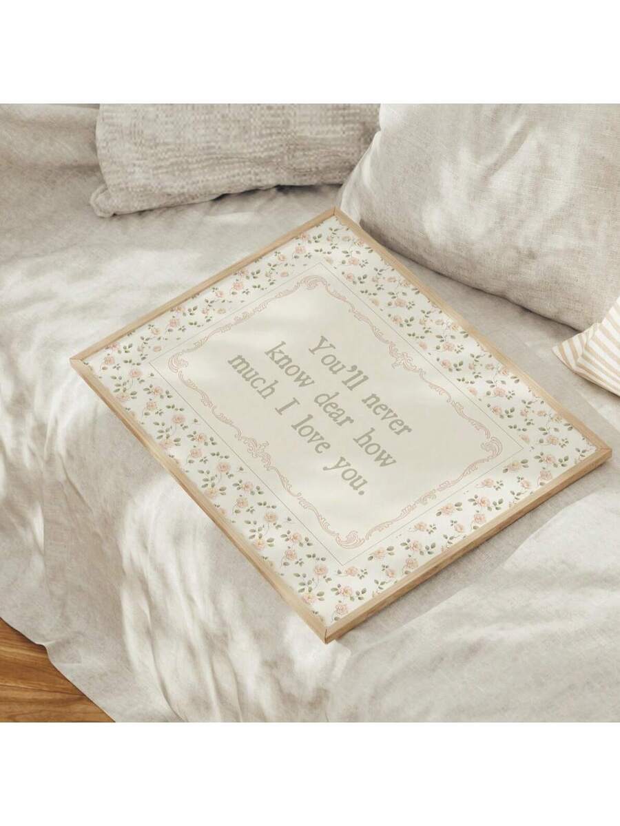 Pastel botanical love quote artwork styled on neutral bedroom bedding