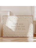 Horizontal pastel floral love quote artwork beside a bright window