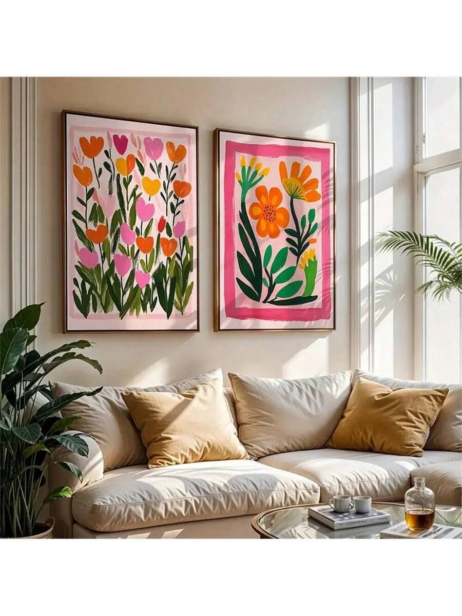 Two framed floral wall art prints on floor labeled A and B with pink orange yellow flowers and gold frames