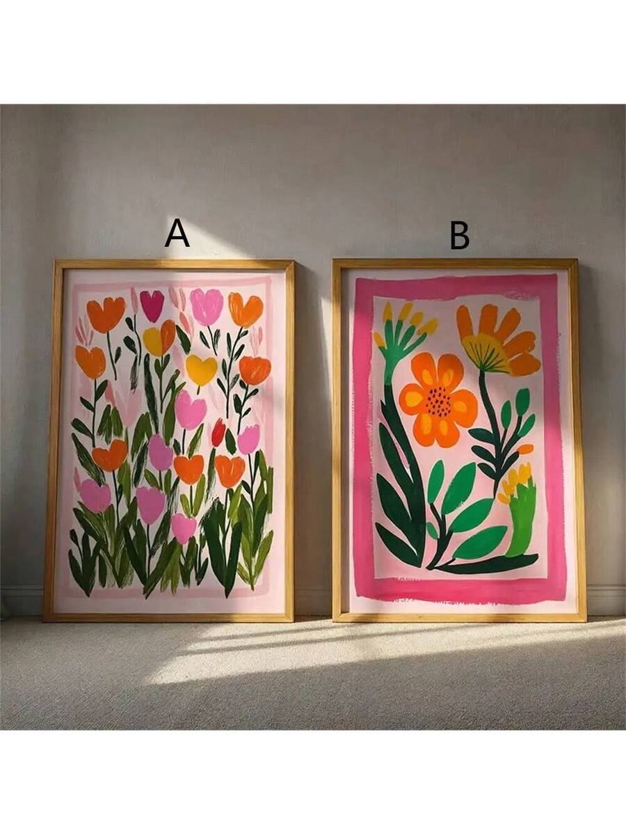 Two framed floral wall art prints on floor labeled A and B with pink orange yellow flowers and gold frames