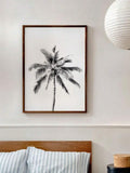 Blue beach artwork styled above a bathroom vanity