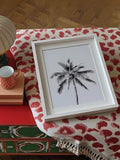 Monochrome coconut palm poster in a dark wood frame