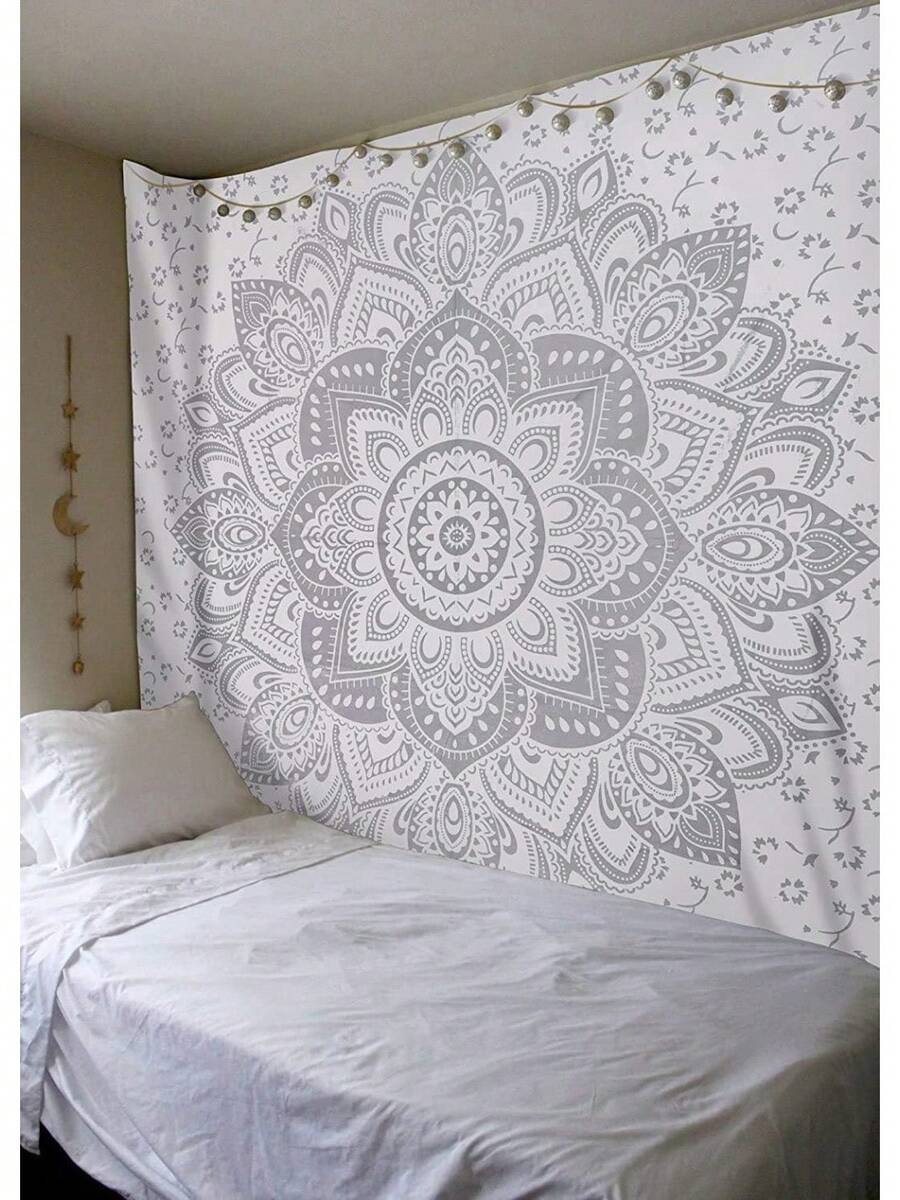 Gray white mandala tapestry wall hanging styled above bed with boho bedroom decor
