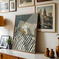 Reading teddy bear wall art styled above a neutral sofa