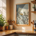 Whimsical reading bear artwork hanging in a neutral kitchen
