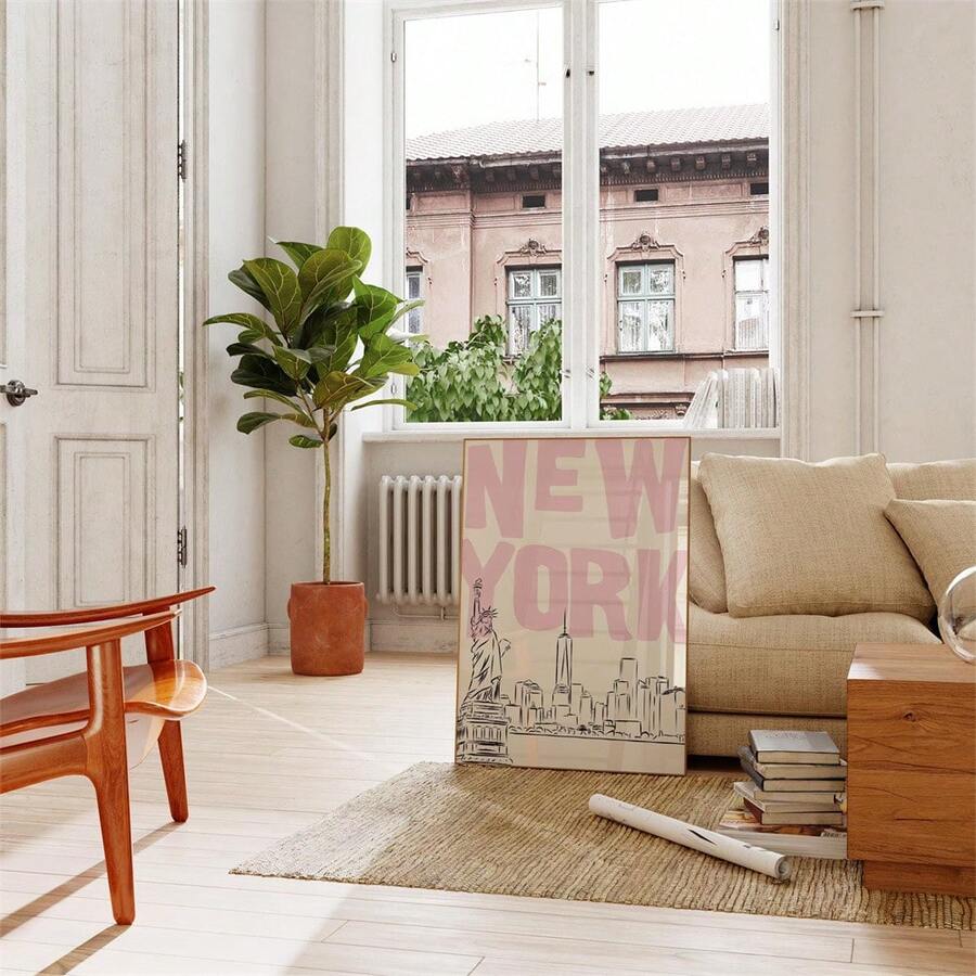 New York cityscape canvas poster beside a sofa plant and bright window