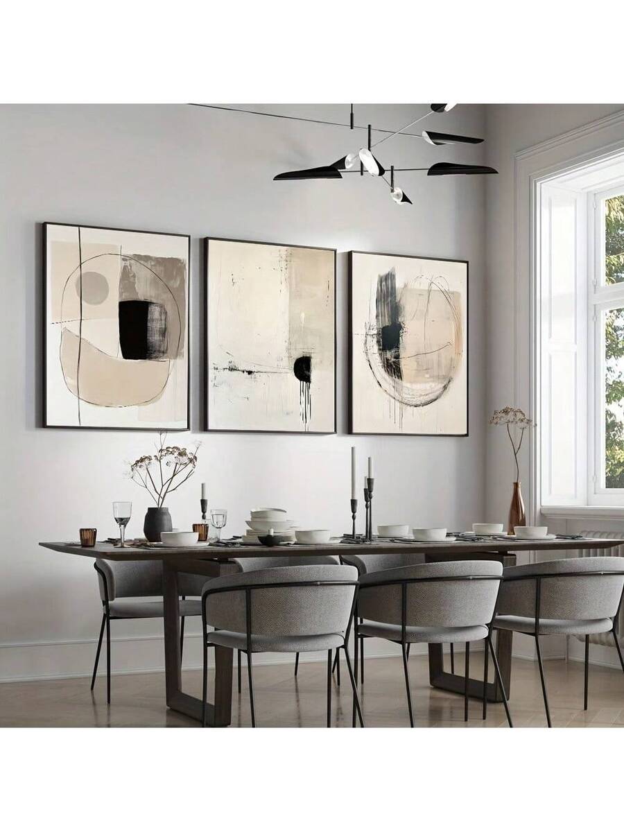 Black framed geometric poster set in a modern dining room