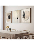 Geometric three-piece wall art in natural frames above dining table