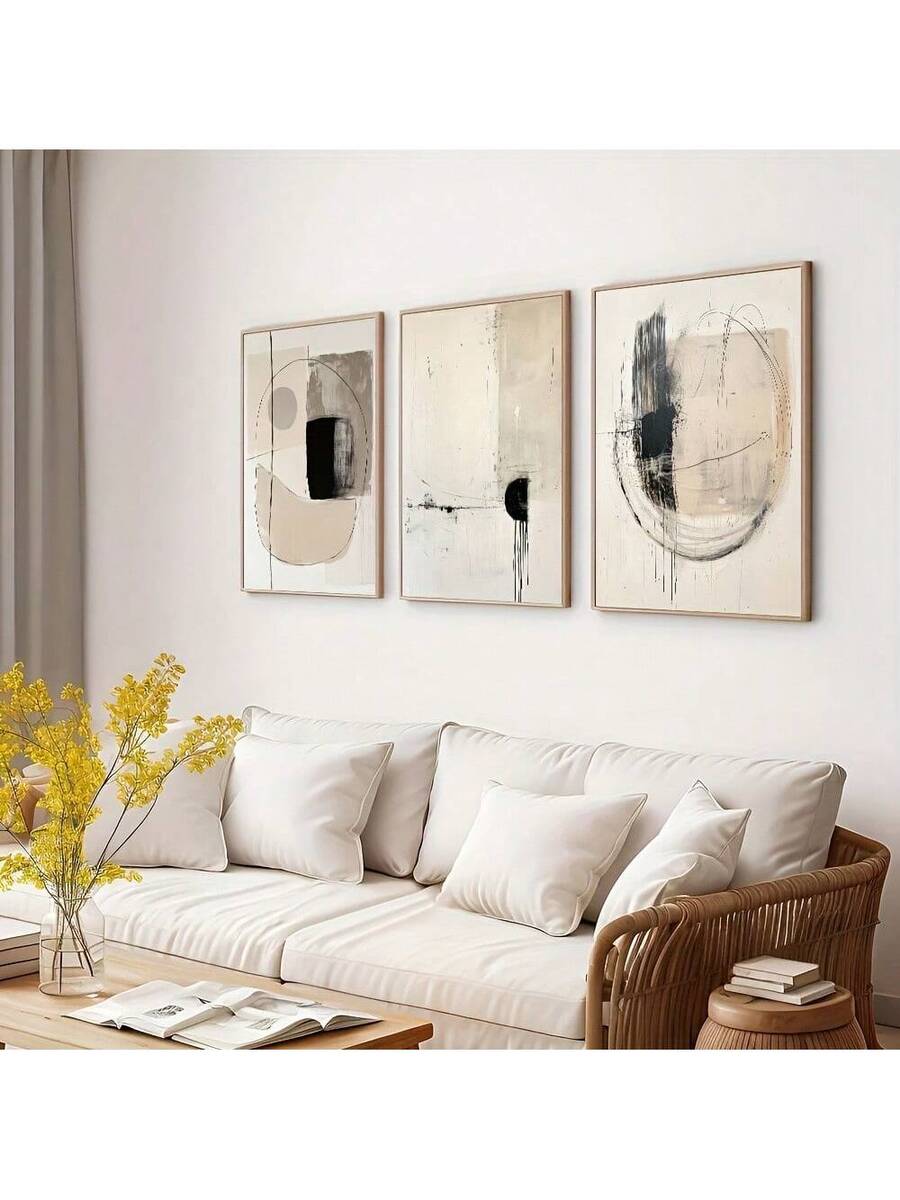 Neutral geometric canvas triptych styled above a cream sofa