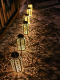 Patio lantern warm night glow with decorative cutout shadows