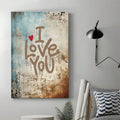 Gallery wrapped love quote canvas hanging in bedroom with graffiti style text and red heart