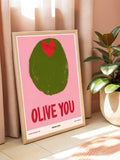 Pink Olive You typographic poster with olive illustration displayed by curtains and plants