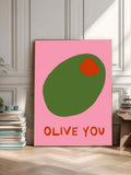 Framed Olive You olive wall art beside books in a colorful reading corner