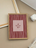 Love quote canvas print styled with natural wood frame in cozy room