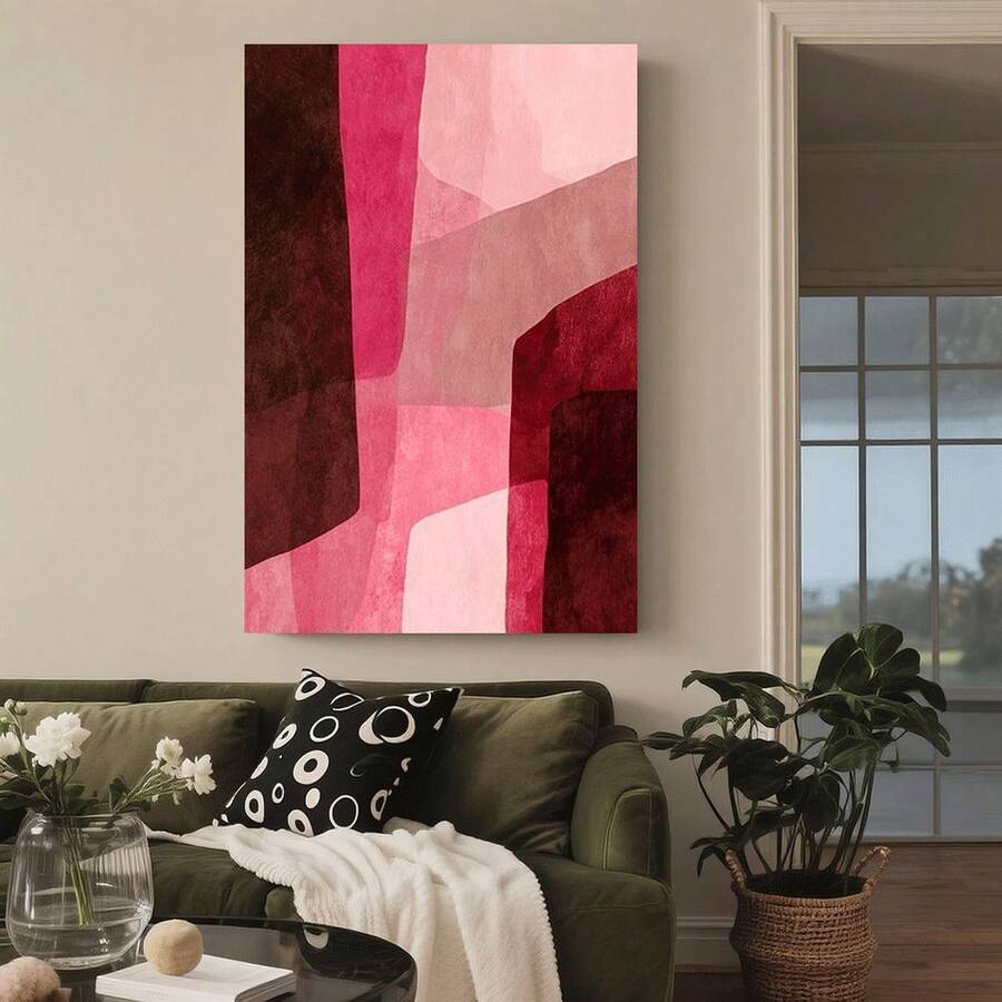 Modern pink burgundy and black abstract canvas poster in a bright blue sofa living room
